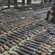 A British soldier in southern Macedonia among AK-47 rifles collected from ethnic Albanian rebels on Sep. 3, 2001.